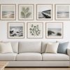 Gallery wall of framed art hung level above a sofa in a Southwest Florida living room